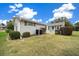 Backyard view shows well maintained lawn with a cozy screened-in porch area at 8188 Sw 108Th Loop, Ocala, FL 34481