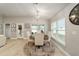 Cozy dining area with round table, four chairs and a chandelier at 8405 Sw 59Th Ter, Ocala, FL 34476