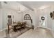 Dining room with a wooden table, chandelier, and arch window at 8405 Sw 59Th Ter, Ocala, FL 34476