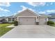 House exterior featuring a two-car garage and well-manicured lawn at 8405 Sw 59Th Ter, Ocala, FL 34476