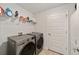 Bright laundry room with washer, dryer, and ample shelving at 8405 Sw 59Th Ter, Ocala, FL 34476