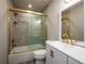 Updated bathroom with gold fixtures, bathtub and white vanity at 8626 Sw 97Th Lane Rd # D, Ocala, FL 34481