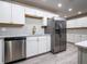 Modern kitchen with white cabinets and stainless steel dishwasher at 8626 Sw 97Th Lane Rd # D, Ocala, FL 34481