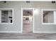 Bright living room with kitchen view, wood-look floors, and built-in shelving at 8626 Sw 97Th Lane Rd # D, Ocala, FL 34481