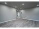 Open living area with grey walls and wood-look floors at 8626 Sw 97Th Lane Rd # D, Ocala, FL 34481