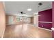 Living room with wood floors, ceiling fan, and large mirror at 8637 Sw 97Th Lane Rd # A, Ocala, FL 34481