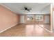 Living room with wood floors, ceiling fan, and mirror wall at 8637 Sw 97Th Lane Rd # A, Ocala, FL 34481