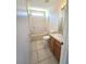 Clean bathroom with tub, toilet and wood vanity at 8697 Se 136Th Ln, Summerfield, FL 34491