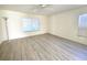 Bright bedroom with wood-look floors and window blinds at 8697 Se 136Th Ln, Summerfield, FL 34491