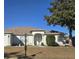 House exterior showcasing a well-maintained lawn and front entrance at 8697 Se 136Th Ln, Summerfield, FL 34491