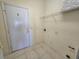 Laundry room with built-in shelving and exterior access at 8697 Se 136Th Ln, Summerfield, FL 34491