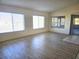 Spacious living room with wood-look floors, large windows, and sliding doors at 8697 Se 136Th Ln, Summerfield, FL 34491