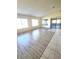 Sunlit living room with wood-look floors and access to a lanai at 8697 Se 136Th Ln, Summerfield, FL 34491