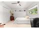 Well-lit bedroom with a queen bed and built-in storage at 8738 Sw 90Th St # B, Ocala, FL 34481