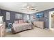 Main bedroom with king bed, light gray walls, and ceiling fan at 8738 Sw 90Th St # B, Ocala, FL 34481