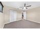 Well-lit bedroom with ceiling fan and access to hallway at 8750 Sw 91St Pl # A, Ocala, FL 34481