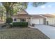 Inviting exterior of charming villa with a two-car garage and well-manicured landscaping at 8750 Sw 91St Pl # A, Ocala, FL 34481