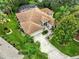 Beautiful home with an attached garage and mature landscaping from an aerial view at 8990 Se 178Th Muirfield Pl, The Villages, FL 32162