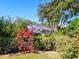 Lush landscaping surrounds a screened pool and patio area at 8990 Se 178Th Muirfield Pl, The Villages, FL 32162