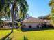 Backyard showcasing the home's exterior, pool, and screened-in patio, with well-maintained landscaping at 8990 Se 178Th Muirfield Pl, The Villages, FL 32162