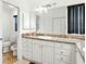 Bathroom with a double sink vanity, granite countertop and plenty of storage at 8990 Se 178Th Muirfield Pl, The Villages, FL 32162