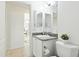 Bathroom featuring a vanity with sink, toilet, large mirror, and views into other rooms in the house at 8990 Se 178Th Muirfield Pl, The Villages, FL 32162