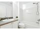 Bright bathroom featuring a shower and tub combination, toilet, vanity with sink, and large mirror at 8990 Se 178Th Muirfield Pl, The Villages, FL 32162