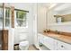 Bright bathroom with granite countertops, white cabinets, and a tiled shower at 8990 Se 178Th Muirfield Pl, The Villages, FL 32162