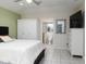 Bedroom with queen bed, wardrobe, and en-suite bathroom at 8990 Se 178Th Muirfield Pl, The Villages, FL 32162