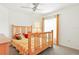 Bright bedroom featuring a ceiling fan, window with patterned curtains, and a bed with a yellow checkered quilt at 8990 Se 178Th Muirfield Pl, The Villages, FL 32162