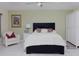 Bedroom with a queen-size bed, nightstand, and white wardrobe at 8990 Se 178Th Muirfield Pl, The Villages, FL 32162