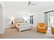 Spacious bedroom featuring neutral carpet, ceiling fan, and access to a private patio at 8990 Se 178Th Muirfield Pl, The Villages, FL 32162