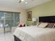 Bedroom with a queen bed, side table, and window with garden view at 8990 Se 178Th Muirfield Pl, The Villages, FL 32162