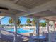 The community pool features ample seating, with palm trees that add a touch of tropical luxury to the outdoor space at 8990 Se 178Th Muirfield Pl, The Villages, FL 32162