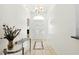 Bright foyer features tiled floors, decorative vases, and a chandelier, creating an elegant entrance at 8990 Se 178Th Muirfield Pl, The Villages, FL 32162