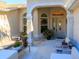 Covered entryway with tiled floor, seating area, and potted plants at 8990 Se 178Th Muirfield Pl, The Villages, FL 32162