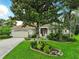 Charming single-story home boasts lush landscaping, a well-manicured lawn, and a welcoming two-car garage at 8990 Se 178Th Muirfield Pl, The Villages, FL 32162