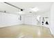 Large garage featuring lots of storage space, an epoxy floor, a large garage door and garage door opener at 8990 Se 178Th Muirfield Pl, The Villages, FL 32162