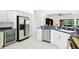 Open kitchen showcases stainless steel refrigerator, sleek countertops, and convenient wine cooler at 8990 Se 178Th Muirfield Pl, The Villages, FL 32162