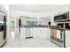 Modern kitchen with stainless steel appliances, white cabinetry, and ample counter space for cooking at 8990 Se 178Th Muirfield Pl, The Villages, FL 32162