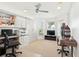 Home office with built-in cabinets, work spaces, and a carpeted floor at 8990 Se 178Th Muirfield Pl, The Villages, FL 32162
