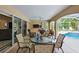 Relaxing covered patio with a ceiling fan, outdoor dining, and views of the pool and screened enclosure at 8990 Se 178Th Muirfield Pl, The Villages, FL 32162