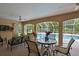 Covered patio with a ceiling fan and outdoor dining and seating areas overlooking the pool at 8990 Se 178Th Muirfield Pl, The Villages, FL 32162