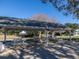 Covered picnic area with multiple picnic tables, perfect for outdoor gatherings and enjoying the community's green spaces at 8990 Se 178Th Muirfield Pl, The Villages, FL 32162