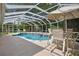 Screened in pool with a spa, and outdoor seating at 8990 Se 178Th Muirfield Pl, The Villages, FL 32162