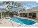 Beautiful pool and spa area with a screened enclosure and an outdoor dining space at 8990 Se 178Th Muirfield Pl, The Villages, FL 32162