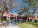 Red barn-style recreation center with rocking chairs at 8990 Se 178Th Muirfield Pl, The Villages, FL 32162