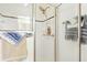 Tiled walk-in shower with glass doors and a rainfall shower head at 8990 Se 178Th Muirfield Pl, The Villages, FL 32162