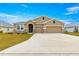 Tan two-car garage house with stone accents at 9181 Sw 49Th Ct, Ocala, FL 34476