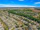 Aerial view of a house in a residential neighborhood with a golf course nearby at 9470 Sw 66Th Loop, Ocala, FL 34481